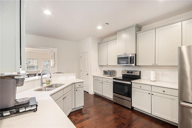 kitchen featuring stainless steel appliances, sink, and white cabinets