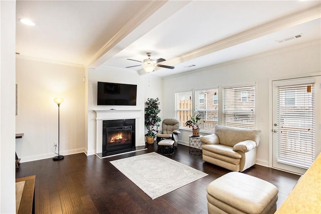 living room with ornamental molding, dark hardwood / wood-style floors, and ceiling fan