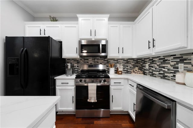 kitchen featuring stainless steel appliances, white cabinets, backsplash, light stone countertops, and dark wood-type flooring