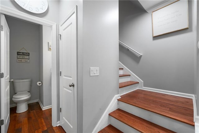 stairs with wood finished floors and baseboards