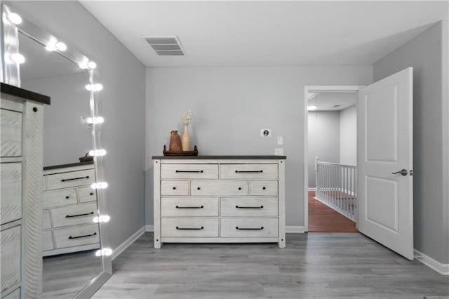 bedroom with light wood finished floors and baseboards