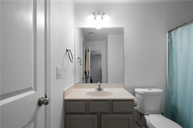 bathroom featuring vanity, toilet, and a shower with curtain