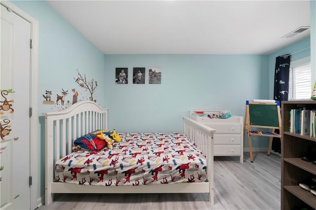 bedroom with wood finished floors and baseboards
