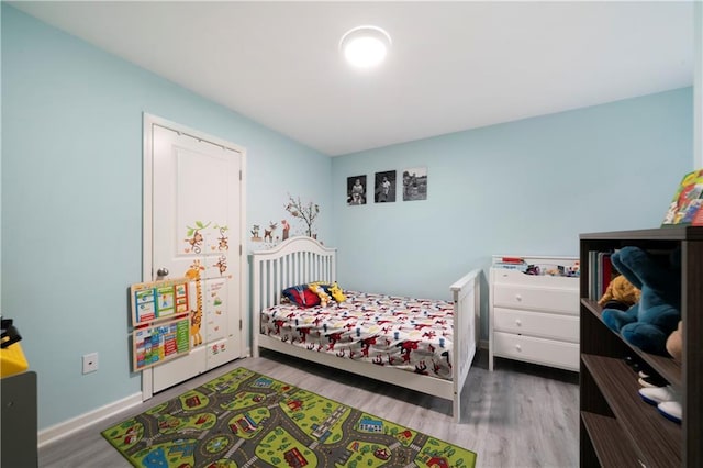 bedroom with wood finished floors and baseboards