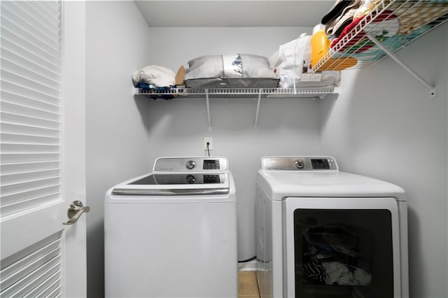 laundry room featuring independent washer and dryer and tile patterned flooring