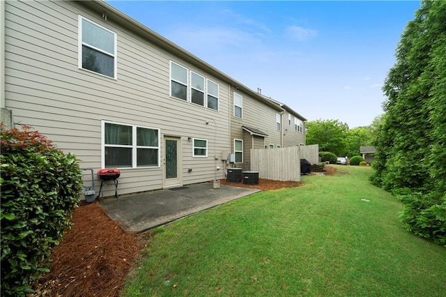 rear view of property featuring a patio and central air condition unit