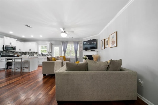 living room featuring crown molding, dark wood-style flooring, ceiling fan, and recessed lighting