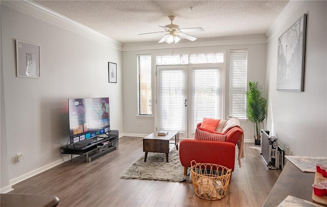 living room with ornamental molding, a textured ceiling, hardwood / wood-style flooring, and ceiling fan