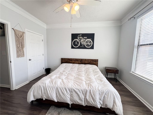 bedroom featuring a textured ceiling, dark hardwood / wood-style flooring, ornamental molding, and ceiling fan