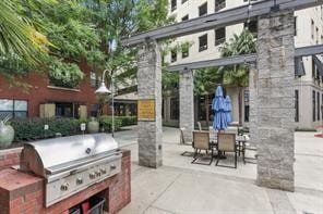 view of patio featuring a grill and an outdoor kitchen