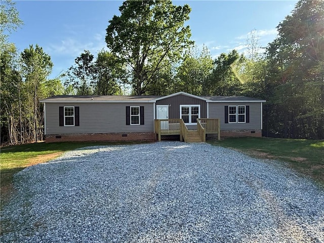 332 Dewaters Rd, Commerce, GA 30529 - manufactured / mobile home featuring crawl space, driveway, a deck, and view of scattered trees