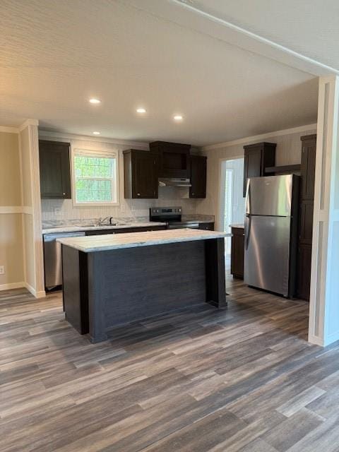 332 Dewaters Rd, Commerce, GA 30529 - kitchen with stainless steel appliances, under cabinet range hood, wood finished floors, a kitchen island, and light countertops