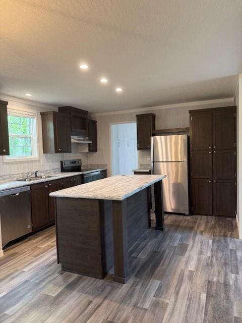 332 Dewaters Rd, Commerce, GA 30529 - kitchen with appliances with stainless steel finishes, under cabinet range hood, light countertops, wood finished floors, and dark brown cabinetry