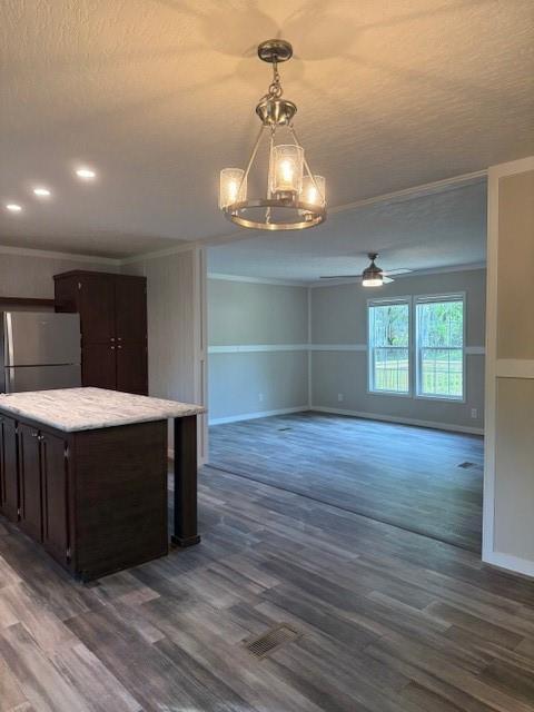 332 Dewaters Rd, Commerce, GA 30529 - kitchen featuring freestanding refrigerator, crown molding, dark brown cabinets, dark wood finished floors, and pendant lighting