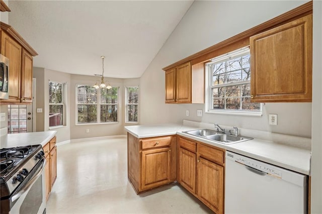 1559 Hillary Cove Ct, Lawrenceville, GA 30043 - kitchen with appliances with stainless steel finishes, a sink, a chandelier, vaulted ceiling, and light countertops
