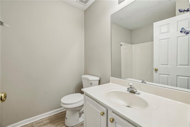 1559 Hillary Cove Ct, Lawrenceville, GA 30043 - bathroom with toilet, wood finished floors, vanity, a shower, and baseboards