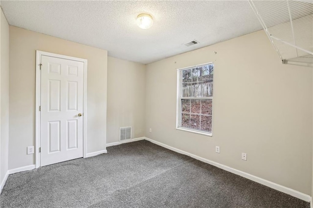1559 Hillary Cove Ct, Lawrenceville, GA 30043 - unfurnished bedroom with a textured ceiling, carpet floors, and baseboards
