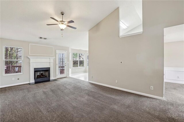 1559 Hillary Cove Ct, Lawrenceville, GA 30043 - unfurnished living room with carpet flooring, a ceiling fan, plenty of natural light, a fireplace, and lofted ceiling
