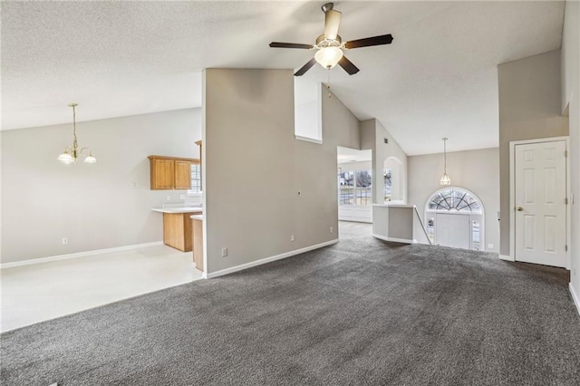 1559 Hillary Cove Ct, Lawrenceville, GA 30043 - unfurnished living room with a chandelier, high vaulted ceiling, a ceiling fan, carpet flooring, and baseboards