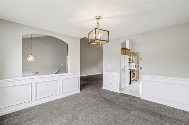 1559 Hillary Cove Ct, Lawrenceville, GA 30043 - unfurnished room with light carpet, arched walkways, a wainscoted wall, a chandelier, and a textured ceiling