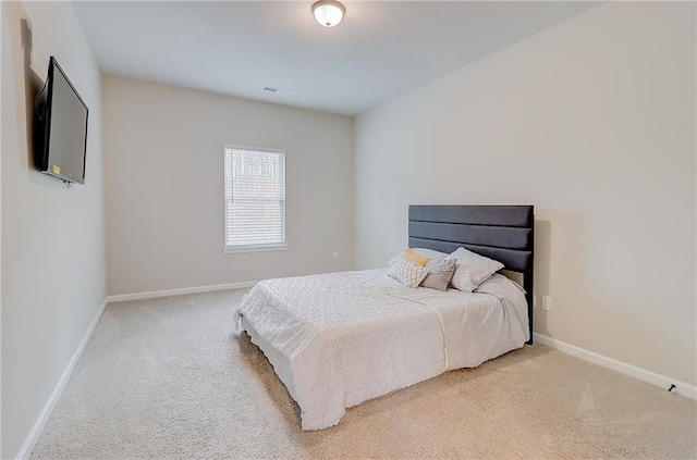 bedroom featuring light carpet, baseboards, and visible vents