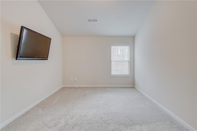 carpeted empty room featuring baseboards and visible vents