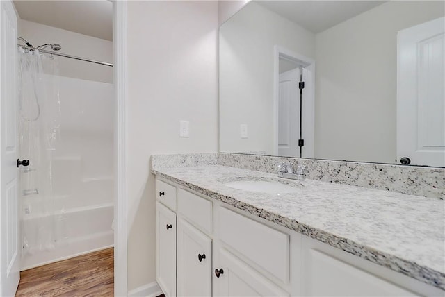 bathroom with wood finished floors, shower / tub combo, and vanity