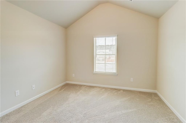 unfurnished room featuring baseboards, carpet floors, and vaulted ceiling