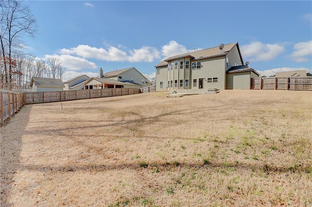 back of property with a fenced backyard