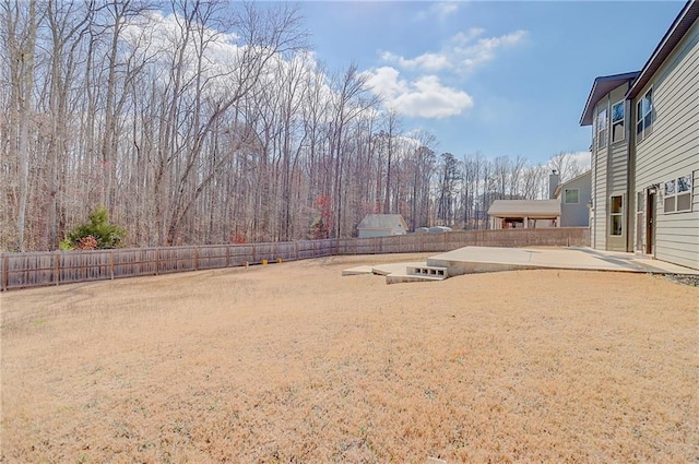 view of yard featuring fence and a patio