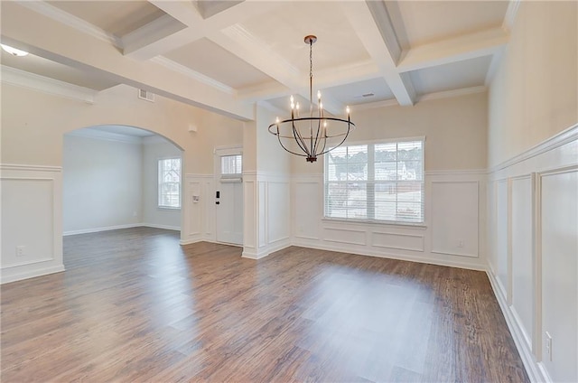 unfurnished dining area featuring wood finished floors, a decorative wall, beamed ceiling, arched walkways, and an inviting chandelier