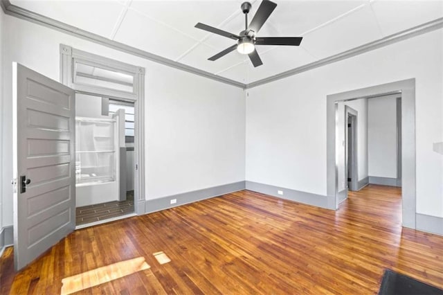 unfurnished bedroom featuring wood-type flooring, baseboards, ceiling fan, and crown molding