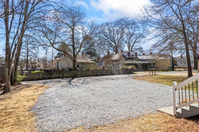 view of yard with fence and a residential view