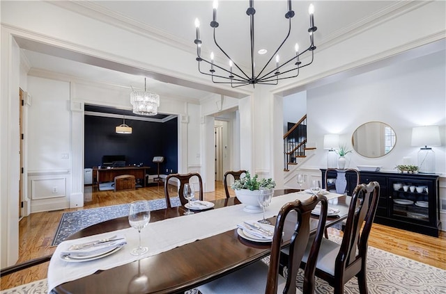 dining area with light hardwood / wood-style floors and crown molding