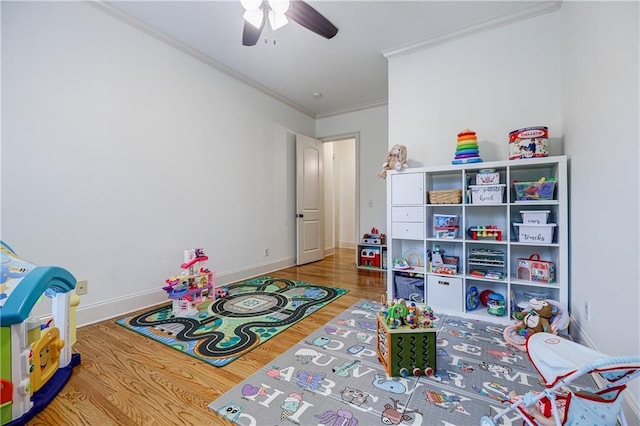 game room featuring hardwood / wood-style flooring, ceiling fan, and ornamental molding