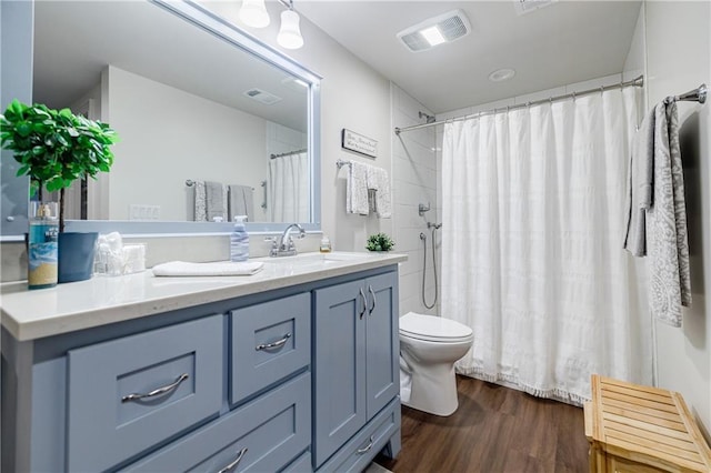 bathroom featuring hardwood / wood-style floors, vanity, radiator, toilet, and walk in shower