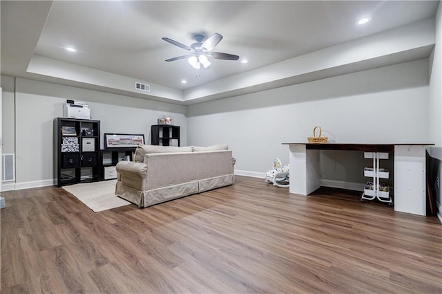 bedroom featuring hardwood / wood-style floors and a raised ceiling