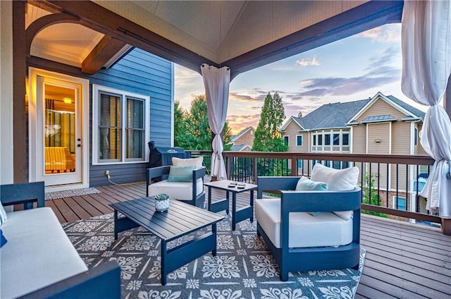 deck at dusk featuring an outdoor living space