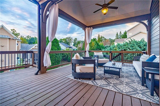 deck with outdoor lounge area and ceiling fan