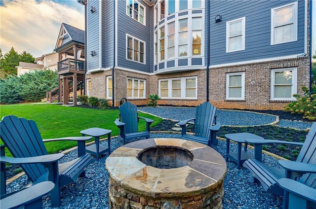 patio terrace at dusk with a yard and a fire pit