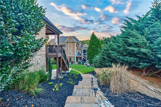 yard at dusk with a wooden deck