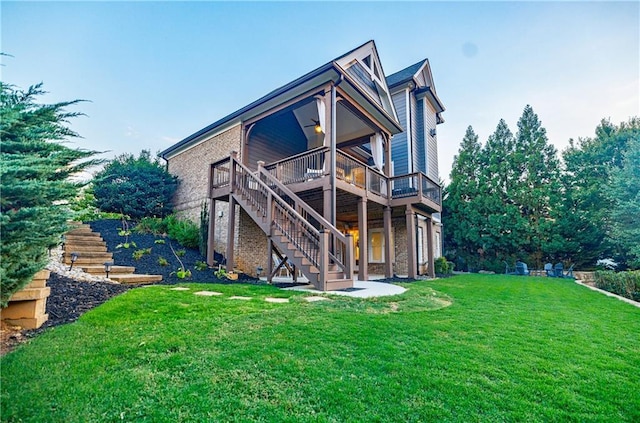 rear view of property with a lawn and a wooden deck