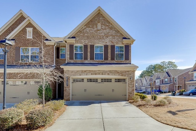 view of front facade with a residential view, concrete driveway, brick siding, and an attached garage