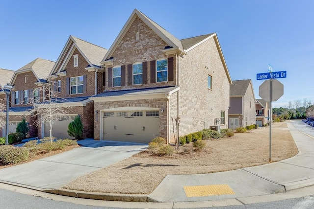 view of front of house with concrete driveway, brick siding, an attached garage, and a residential view