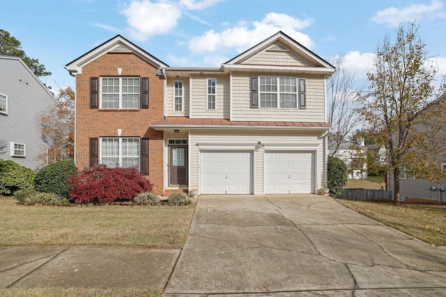 view of front of property featuring a garage and a front lawn