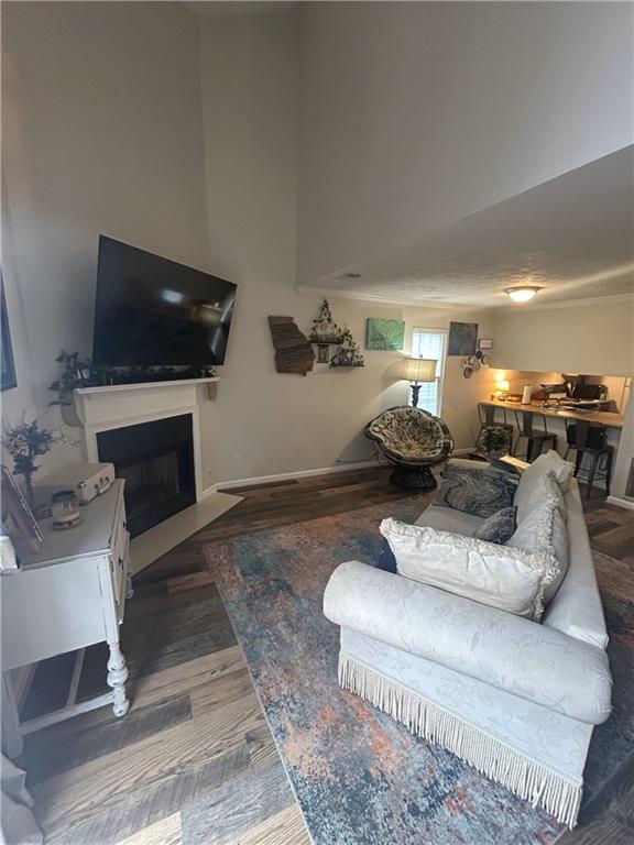 3414 Bayshore Dr, Atlanta, GA 30340 - living room featuring a fireplace with flush hearth, wood finished floors, and baseboards