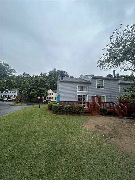 3414 Bayshore Dr, Atlanta, GA 30340 - rear view of house with a yard and a wooden deck