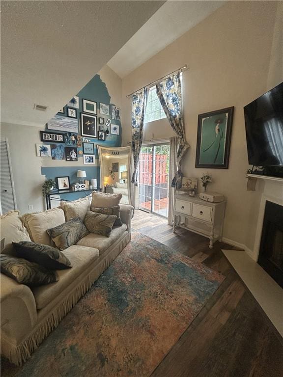 3414 Bayshore Dr, Atlanta, GA 30340 - living area featuring wood finished floors, a fireplace with flush hearth, a textured ceiling, and baseboards
