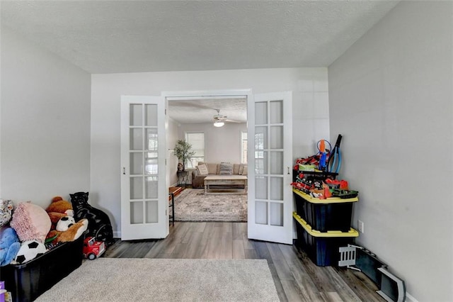 5385 Spotted Fawn Ct, Suwanee, GA 30024 - interior space featuring french doors, wood finished floors, ceiling fan, and a textured ceiling