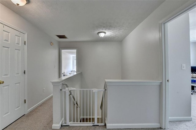 5385 Spotted Fawn Ct, Suwanee, GA 30024 - hall featuring an upstairs landing, carpet, and a textured ceiling